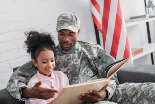 veteran reads book to daughter in new home